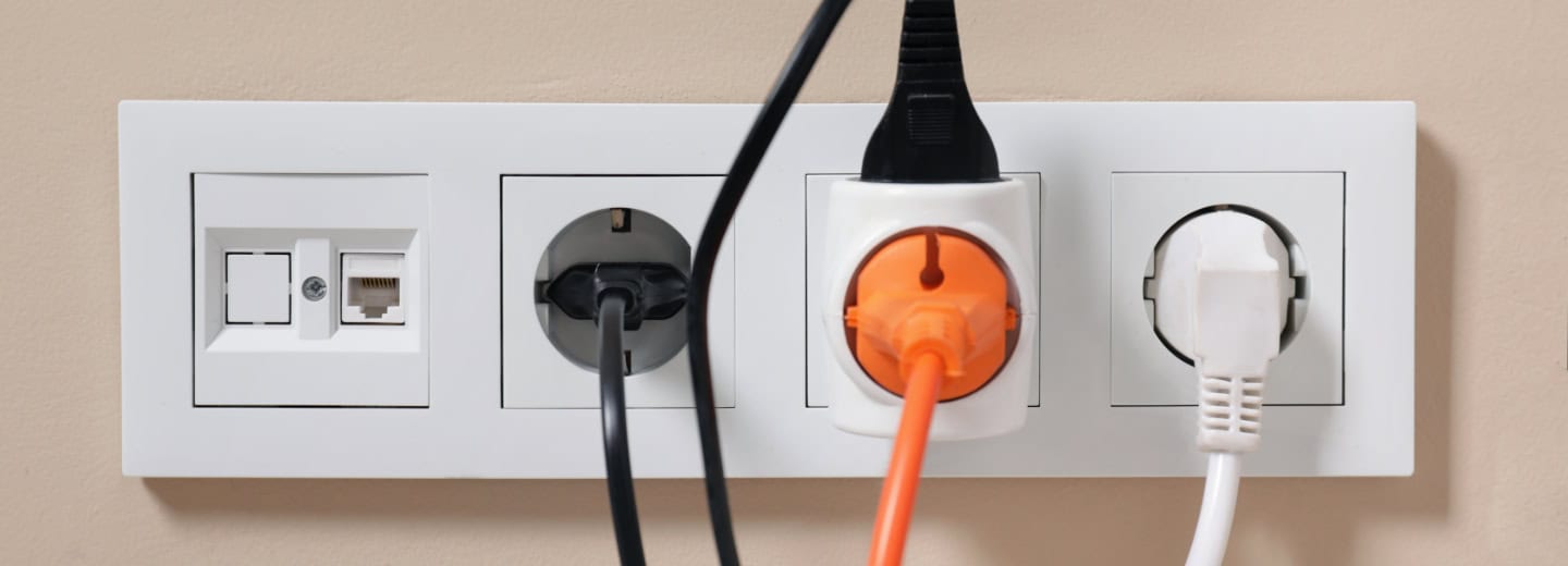 Wall socket panel with three power plugs and an ethernet port, perfect for travelers to charge fitness devices at the hotel gym.
